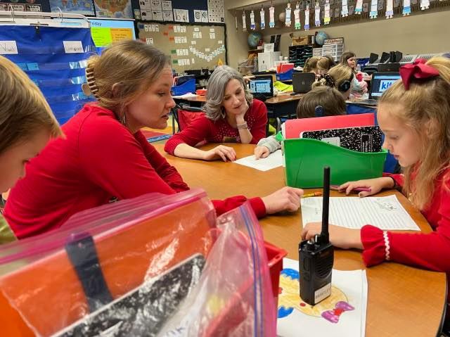  Mrs. Jessica Saum visits during small group reading groups with Mrs. Pickett